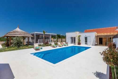 a swimming pool in the backyard of a villa at Vila Gallo in Galovac