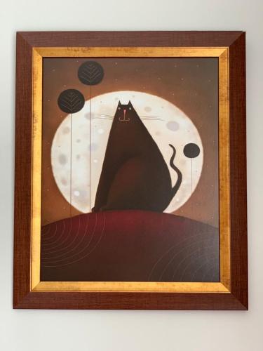 a picture of a black cat in front of the moon at Villa Mona Lisa in Hévíz