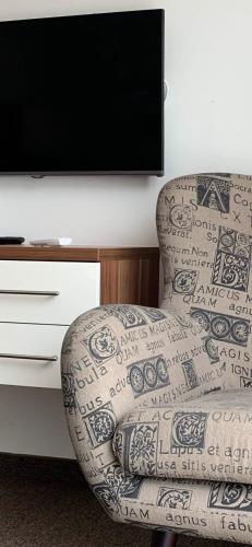 a chair sitting in front of a tv at Villa Mona Lisa in Hévíz