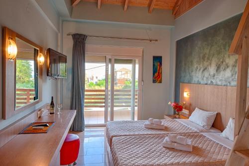 a hotel room with two beds and a balcony at Giovanni Mare in Kourouta