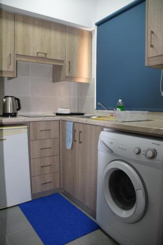 a kitchen with a washing machine in a kitchen at Sea Krystel 603 in Larnaca