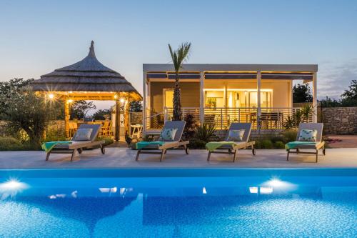 a house with a swimming pool next to a house at Vila Gallo in Galovac