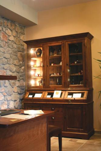 a large wooden cabinet in a room with a table at Karyatis Resort in Synikia Mesi Trikalon