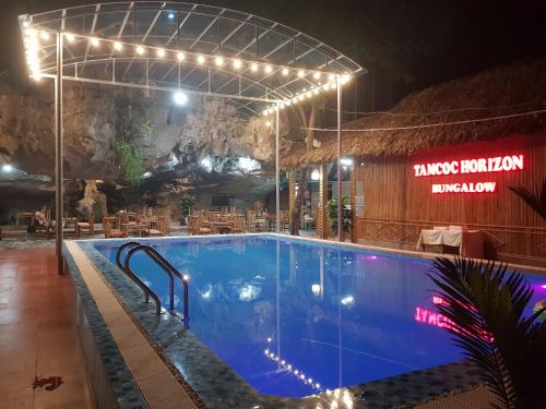 a swimming pool at night with lights above it at Tam Coc Horizon Bungalow in Ninh Binh