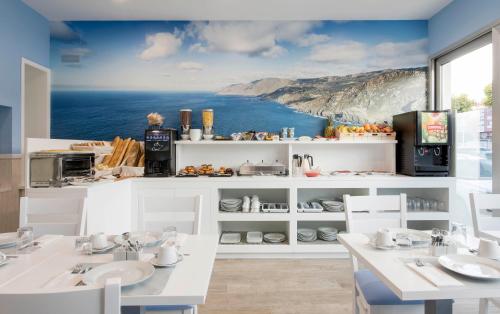 a kitchen with a view of the ocean at Hostal Praia Madalena in Cedeira