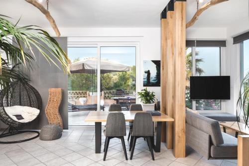 a living room with a table and chairs at Exotic Master-House in a Unique Location! in Lithakia