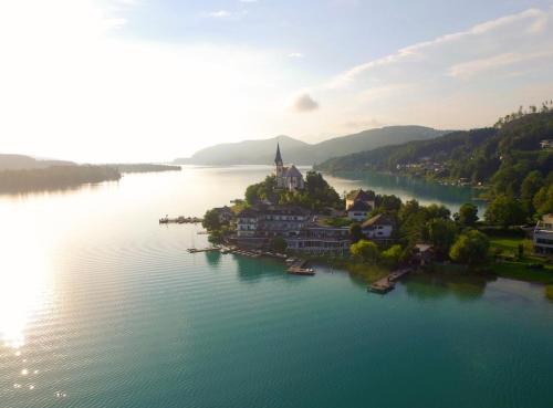 an aerial view of a small island in the middle of a lake at Hotel Linde in Maria Wörth