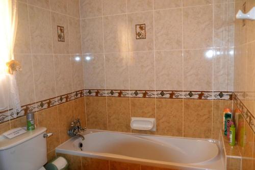a bathroom with a bath tub and a toilet at Silia's Maisonette in Marsaskala