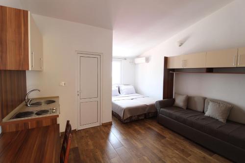 a living room with a couch and a bed in a room at Apartment Dasic in Bar