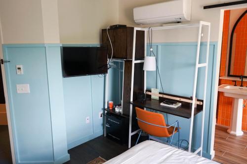 a bedroom with a bunk bed and a desk with a computer at The Russell in Nashville