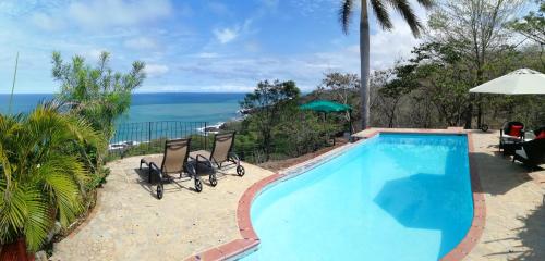 a swimming pool with a view of the ocean at Montezuma Heights in Montezuma