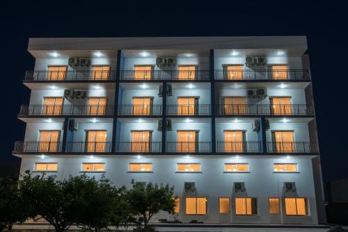 a building with illuminated windows at night at Deniz Airport Suites in North Nicosia