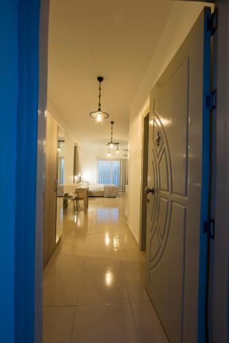 a hallway with a door leading to a living room at Deniz Airport Suites in North Nicosia