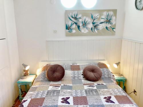 a bedroom with a bed with two pillows on it at FREE PARKING FRONT OF YOUR STUDIO 365d in Lovran