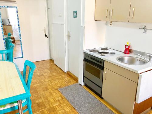 a kitchen with a sink and a stove at FREE PARKING FRONT OF YOUR STUDIO 365d in Lovran