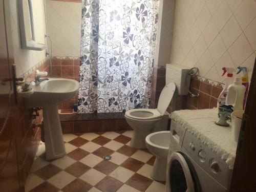 a bathroom with a toilet and a sink at Big apartment in Orikum