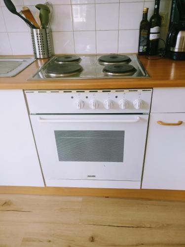 a white stove top oven in a kitchen at Pension Edelweiss Top 25 in Gosau