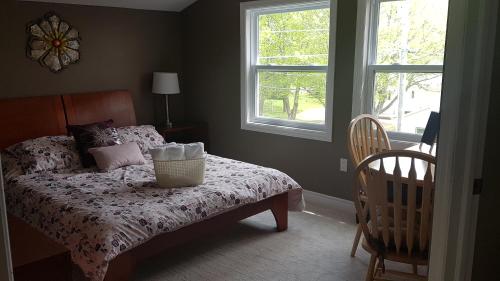 a bedroom with a bed with a basket on it at Small Town Bound Inn in Montague