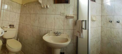 a bathroom with a sink and a toilet and a shower at Morales Guest House in Huaraz