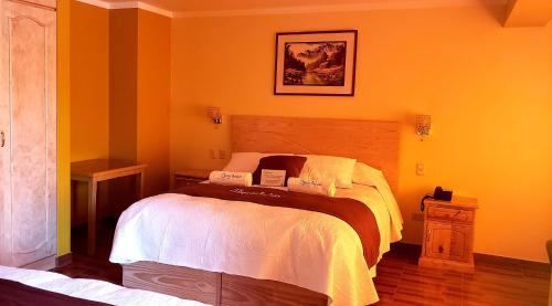 a bedroom with a bed in a yellow room at Morales Guest House in Huaraz