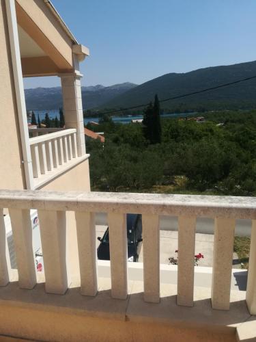 a balcony of a house with a view of a beach at Apartments Ivanka in Ston