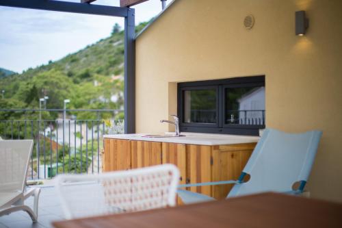 a kitchen with a sink and a table and chairs at Bella Vista Suites in Vis