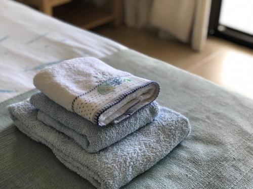 a pile of towels sitting on top of a bed at Private seaview villa in BlackSeaRama - 1st line in Balchik