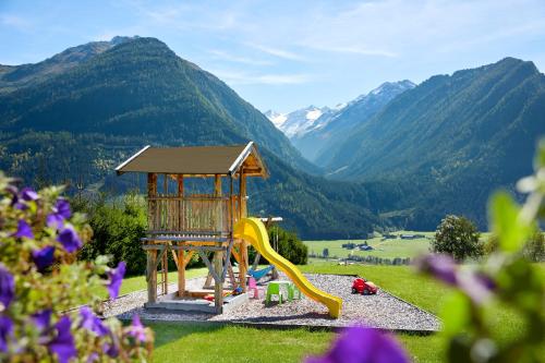 a playground with a yellow slide at Hotel Gasthof Abelhof in Neukirchen am Großvenediger