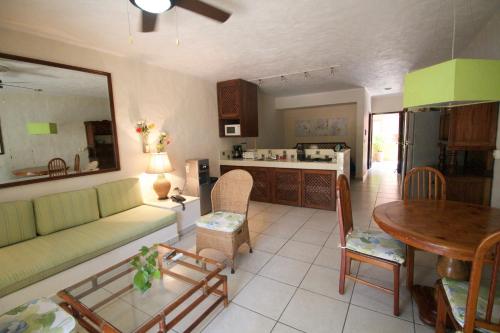a living room with a couch and a table at Villas del Sol en Los Tules in Puerto Vallarta