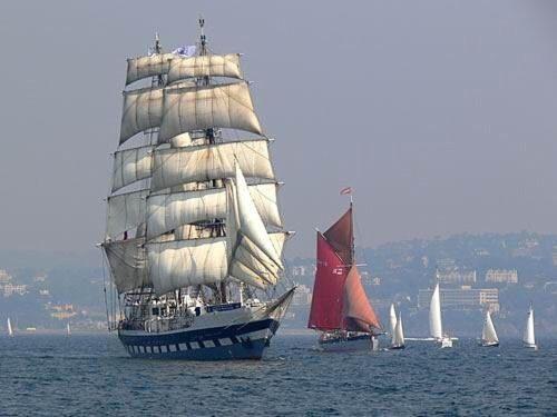 a large sail boat in the water with other boats at Grockle Nook Holiday Apartment in Brixham