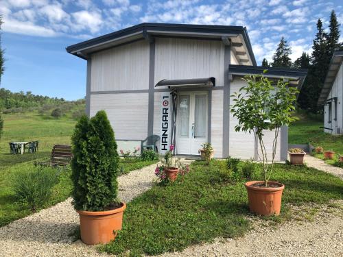 a small house with potted plants in front of it at Podere Badia Valdrago Agriturismo Mugello Circuit in Scarperia