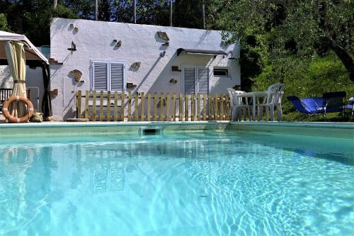 a swimming pool in front of a house at Podere Badia Valdrago Agriturismo Mugello Circuit in Scarperia