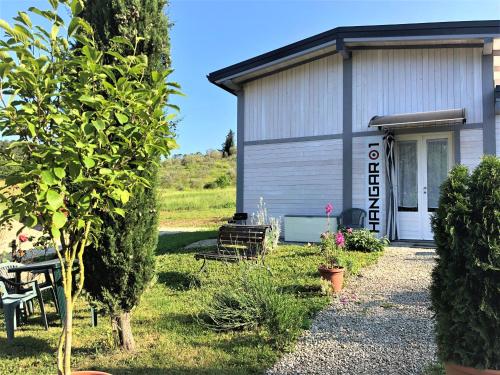 a building with a table and chairs in front of it at Podere Badia Valdrago Agriturismo Mugello Circuit in Scarperia