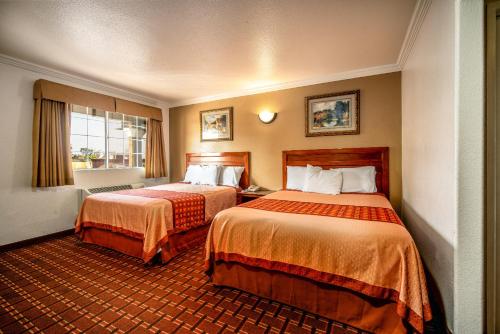 Tempat tidur dalam kamar di Regency Inn & Suites Downey