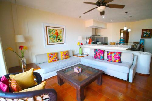 a living room with couches and a coffee table at Villas del Sol en Los Tules in Puerto Vallarta