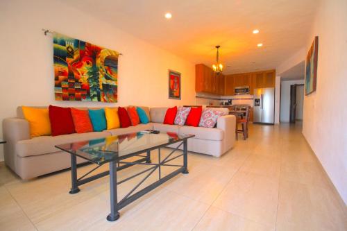a living room with a couch and a table at Villas del Sol en Los Tules in Puerto Vallarta