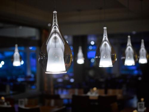 a group of lights hanging in a restaurant at Hotel Holiday Thun in Thun