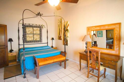 a bedroom with a canopy bed and a mirror at Villas del Sol en Los Tules in Puerto Vallarta