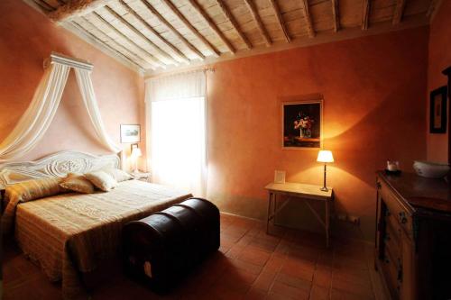 a bedroom with a large bed and a window at Podere La Strega in Siena