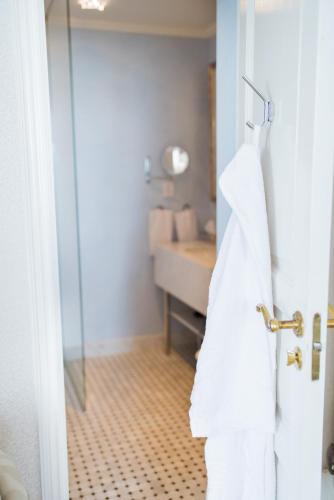 a bathroom with a towel hanging on a door at Mauritzbergs Slott & Golf in Mauritsberg