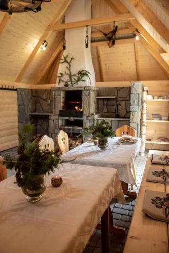a dining room with tables and a stone fireplace at Dom Wypoczynkowy Julia in Białka Tatrzańska