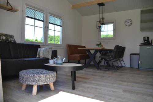 a living room with a couch and a table at Minicamping Shalom in Domburg