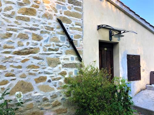 a stone building with a light next to a door at Podere Badia Valdrago Agriturismo Mugello Circuit in Scarperia
