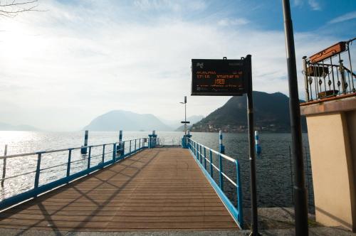 a boardwalk leading into the water with a sign on it at La Casa del Comandante in Sulzano