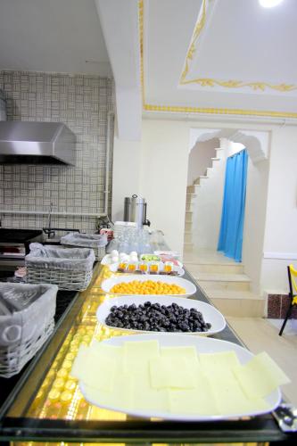 a row of plates of food on a counter in a kitchen at Grand FM Hotel in Istanbul