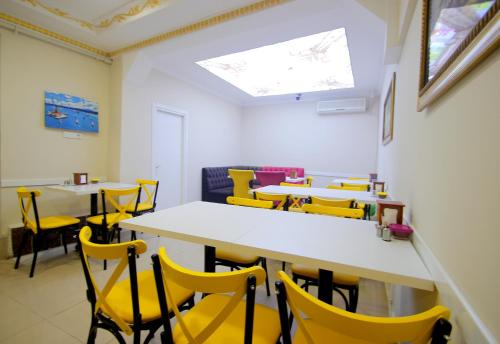 a dining room with yellow chairs and tables at Grand FM Hotel in Istanbul
