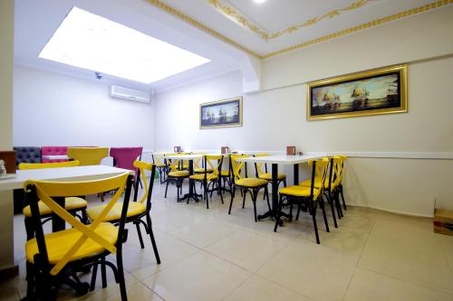 a dining room with tables and yellow chairs at Grand FM Hotel in Istanbul
