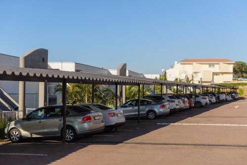 a row of cars parked in a parking lot at Sands Beach Breaks Umdloti Beach View in Umdloti