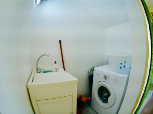 a bathroom with a washing machine and a sink at Ragusa 2 al mare in Marina di Ragusa