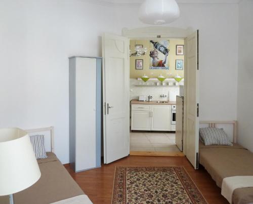 a small room with two beds and a kitchen at Central Apartment in Veszprém